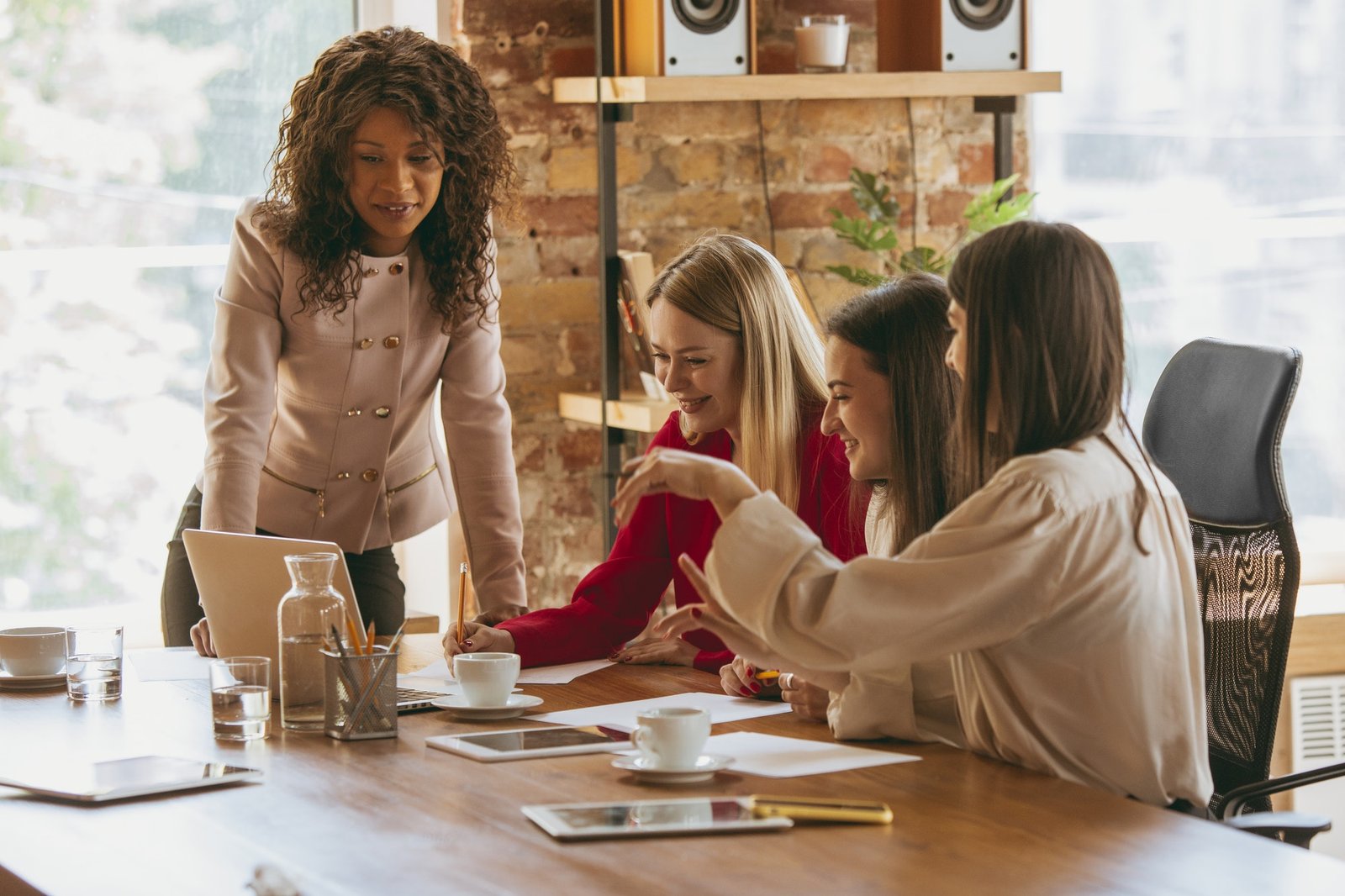 Business young caucasian woman in modern office with team